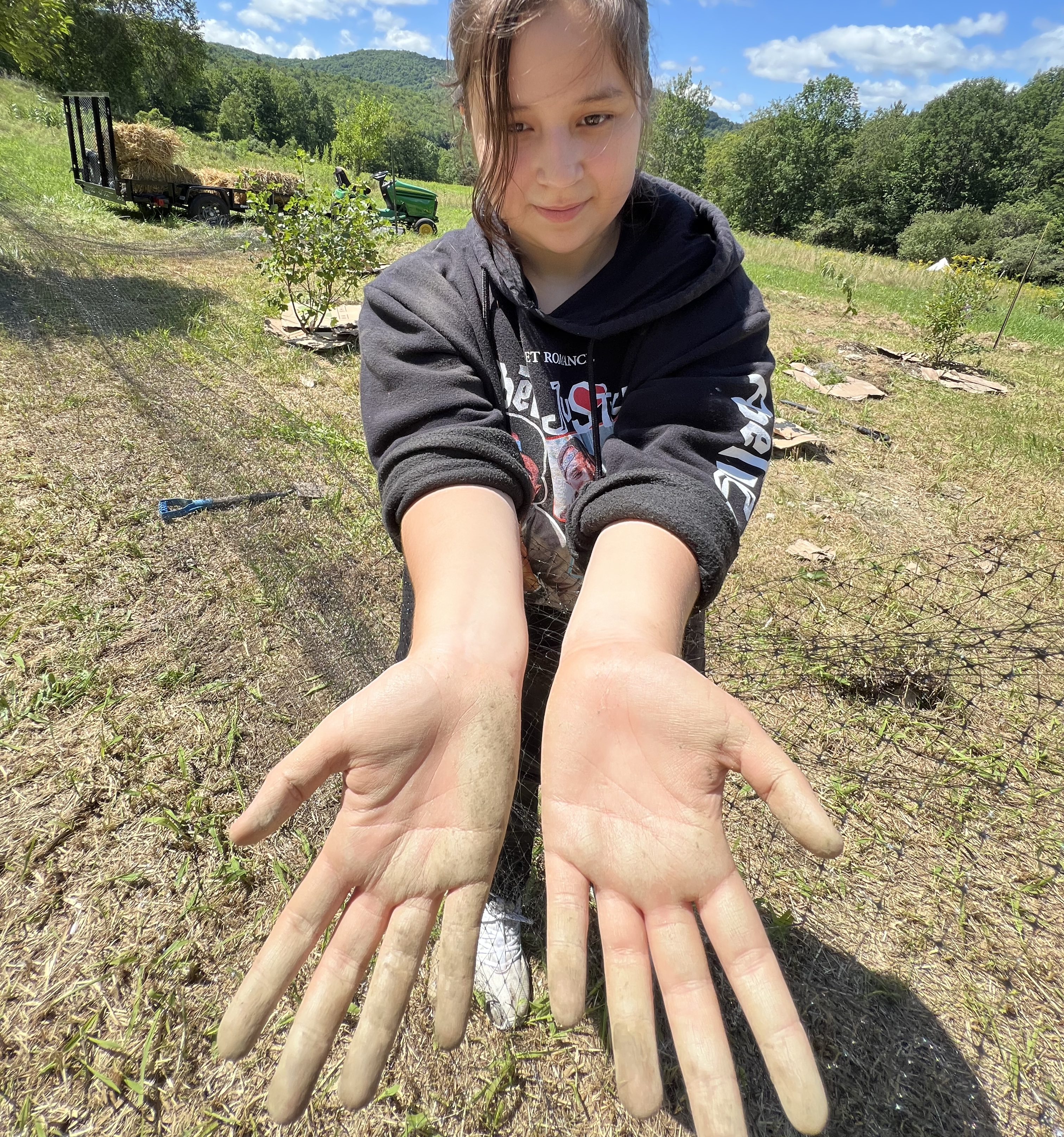 student hands in the field
