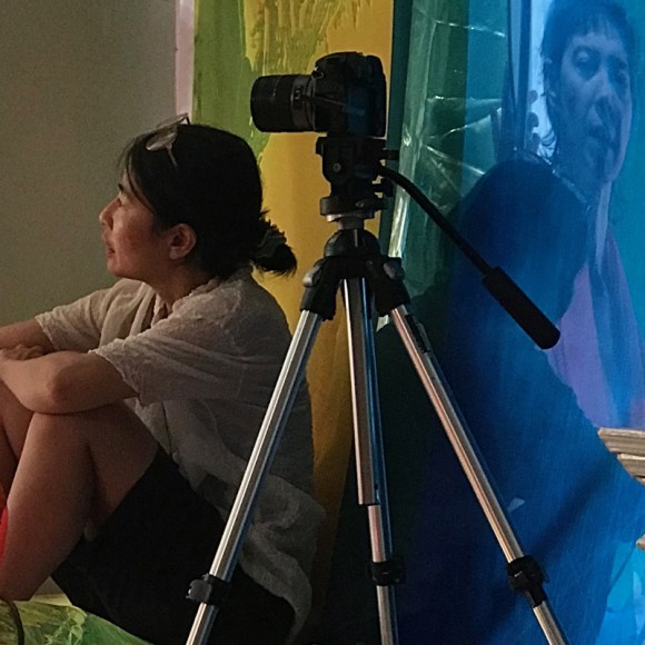 iki sits in front of camera